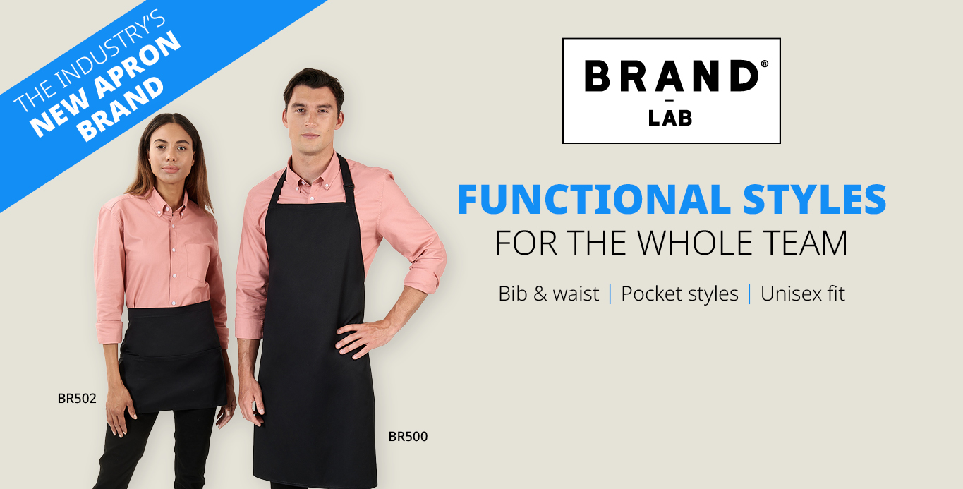 A woman wearing a short waist apron and a man wearing a long apron, both showcasing a new apron brand, standing against a plain background.