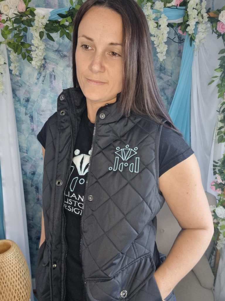 An image showcasing the logo embroidery on the left chest of a vest.