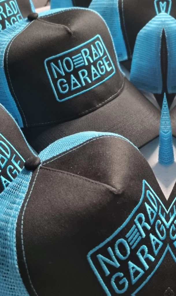 Image displaying black and blue contrast caps with blue logo embroidery.