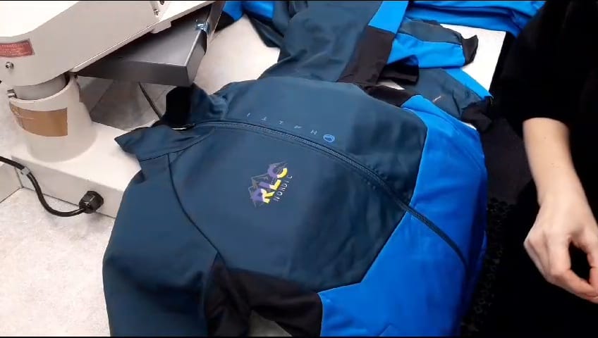 Heat press preparing DTF-printed sheet for application, with personalisation options available